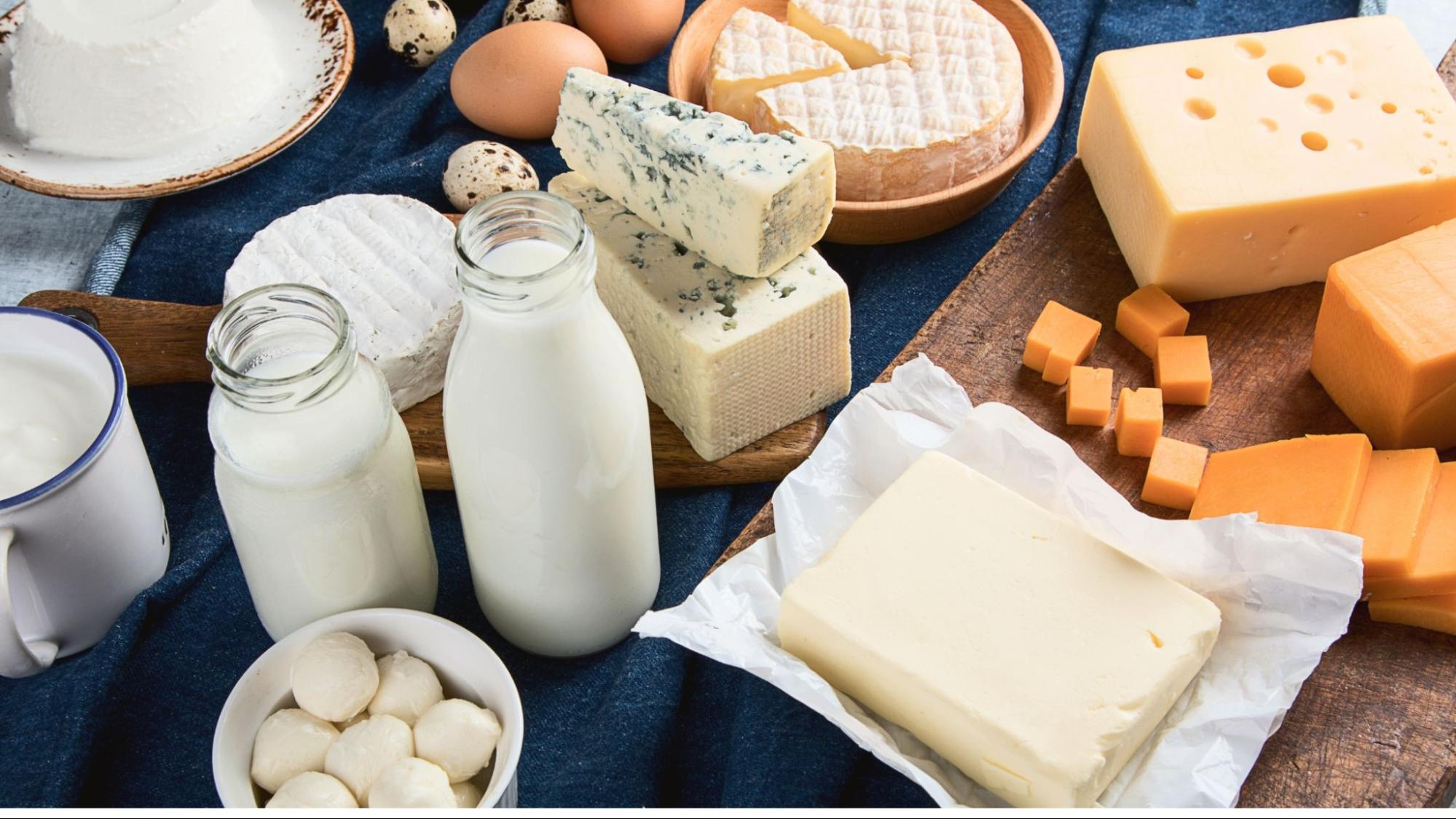 Various packaged food items arranged neatly on wooden table with natural lighting showing different textures and colors